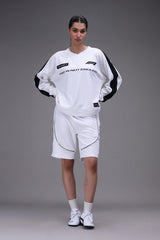 Person wearing a white formula 1 jersey outfit with black accents on a gray background